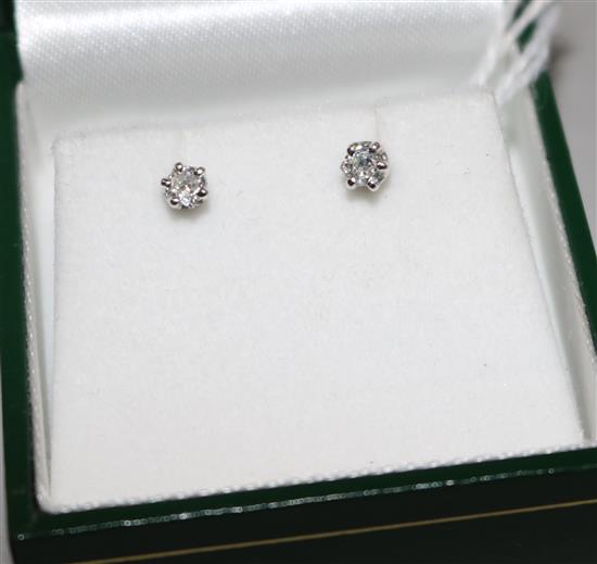 A pair of white metal and solitaire diamond ear studs, in Avalon box